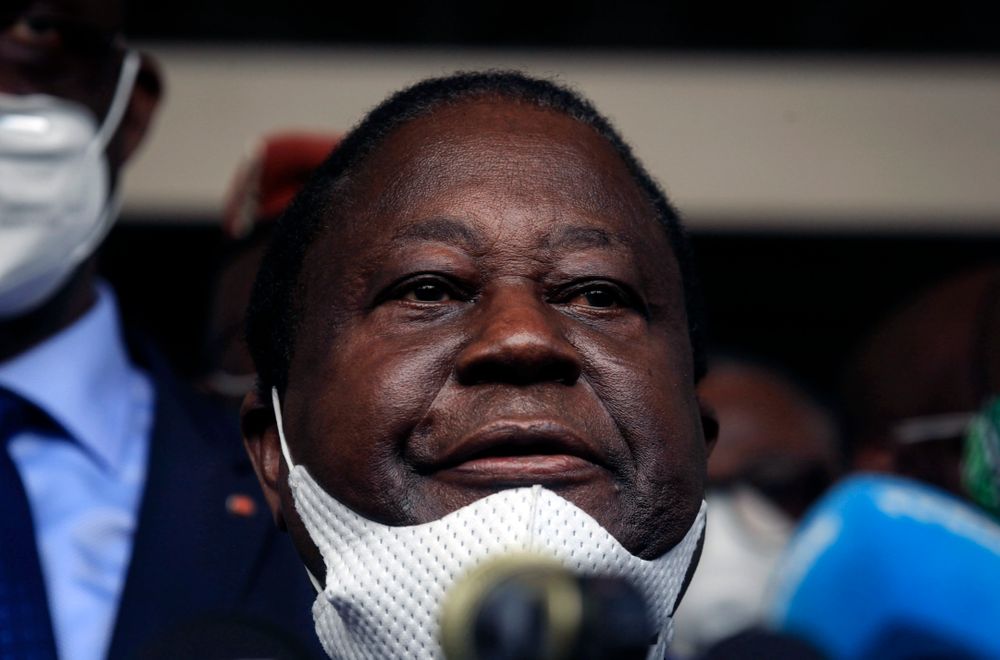 Former president Henri Konan Bedie, of the PDCI-RDA party, speaks to the media after presenting his candidacy at the election commission in Abidjan, Ivory Coast Thursday, Aug. 27, 2020. Two main opposition leaders in Ivory Coast who pose the strongest threat to incumbent President Alassane Ouattara are filing to become official candidates for their parties for October elections. (AP Photo/Diomande Ble Blonde)